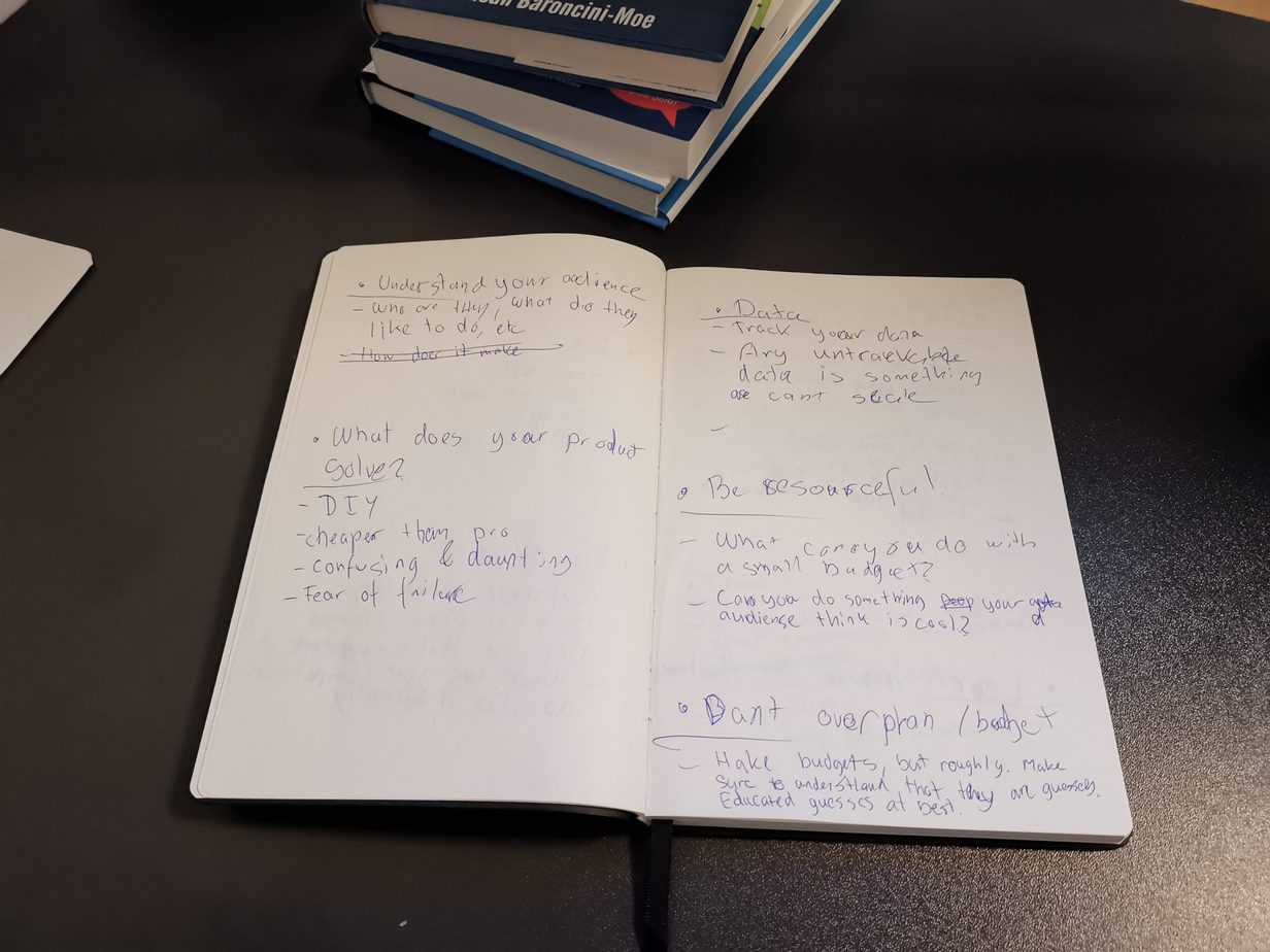 An open handwritten notepad with notes on understanding your audience, tracking data and being resourceful.