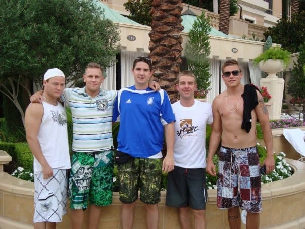 Five friends standing in front of a palm tree and fountain outside a Las Vegas hotel.